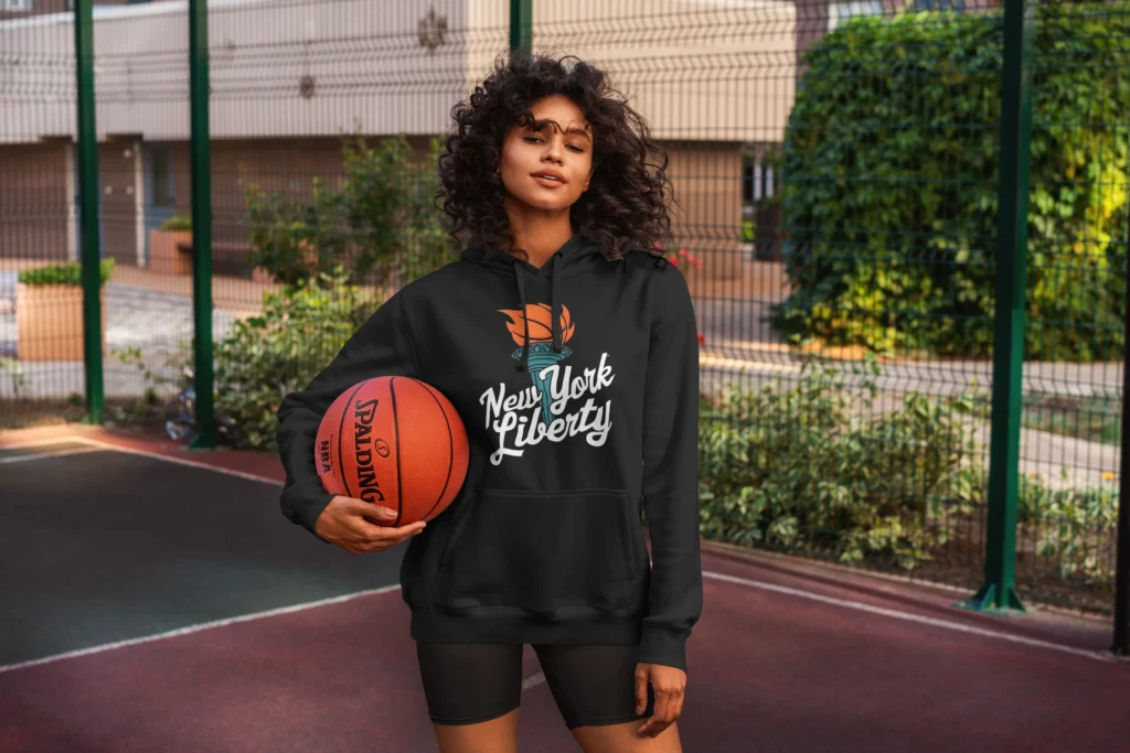 woman holding basketball and wearing Atlanta New York Liberty Hoodie